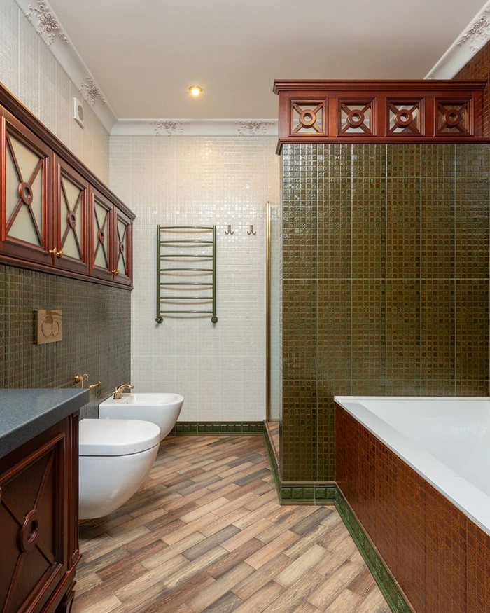 A bathroom with refinished white wall tile and a tub