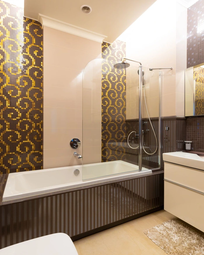 A bright finished bathroom with a white tub and tile after refinishing